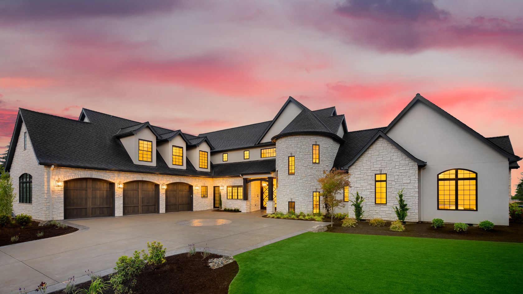 Beautiful White Castle Luxury Home with a green lawn during sunset