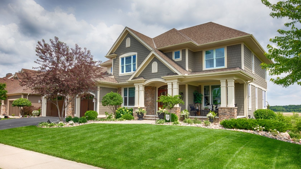 2 storey house with a green lawn on a cloudy day in Toronto for sale