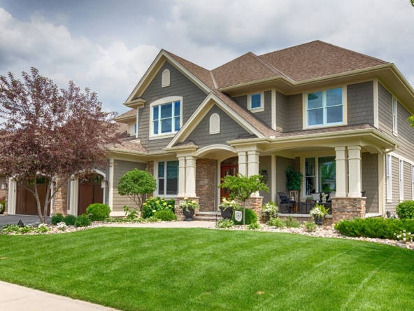 2 storey house with a green lawn on a cloudy day in Toronto for sale